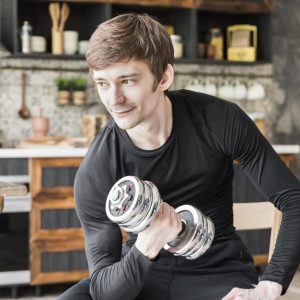 smiling-man-training-with-dumbbell